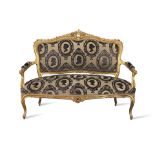 A French late 19th/early 20th century giltwood canape or sofa in the Louis XV style