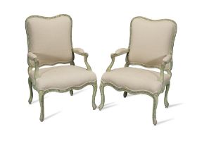 A pair of French painted and parcel gilt walnut fauteuils a la Reine possibly 18th century, in t...