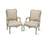 A pair of French painted and parcel gilt walnut fauteuils a la Reine possibly 18th century, in t...