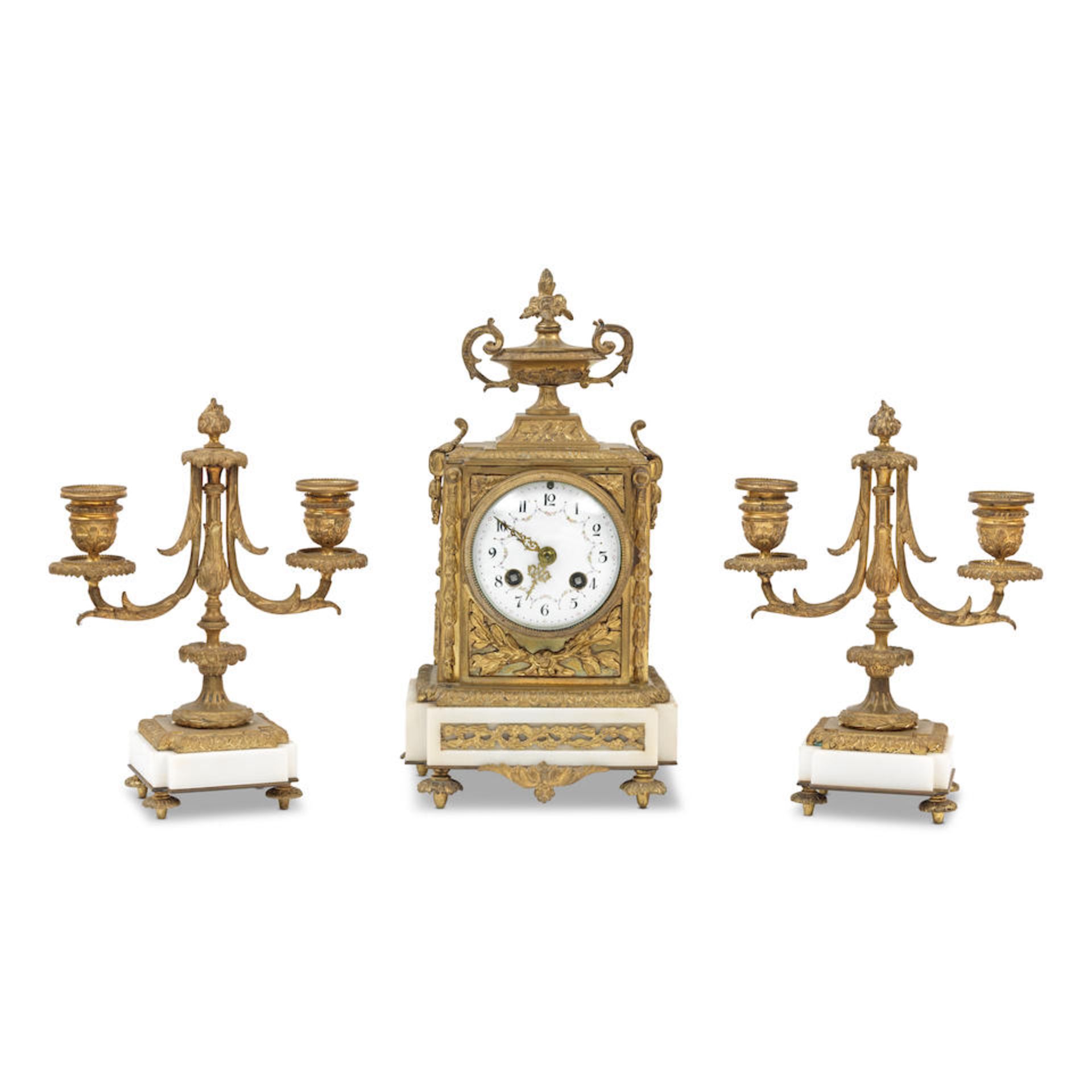 An early 20th century French gilt brass and white marble clock garniture in the Louis XVI taste,...