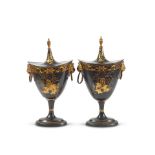 A pair of early 19th century black and gilt chinoiserie japanned toleware chestnut urns (2)