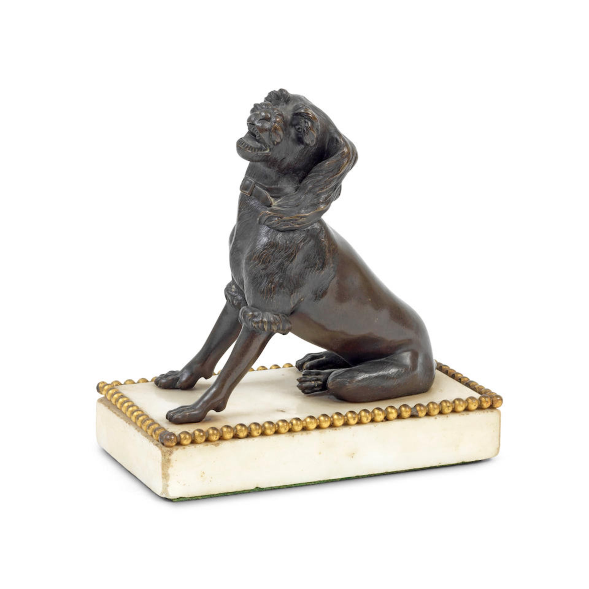 An early 19th century patinated bronze presse-papier model of a dog possibly English
