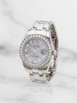 Rolex. A fine lady's 18K white gold automatic calendar bracelet watch with diamond set bezel and...