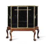 A late Victorian or Edwardian brass mounted shop display cabinet on stand by Trevor Page & Co. 1...