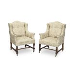 A matched pair of wingback 'box' armchairs The mahogany chair late Victorian, the other example ...