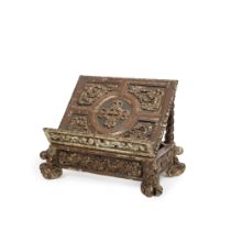 A 19th century carved and silvered and painted wood table top lectern probably Spanish, in the B...