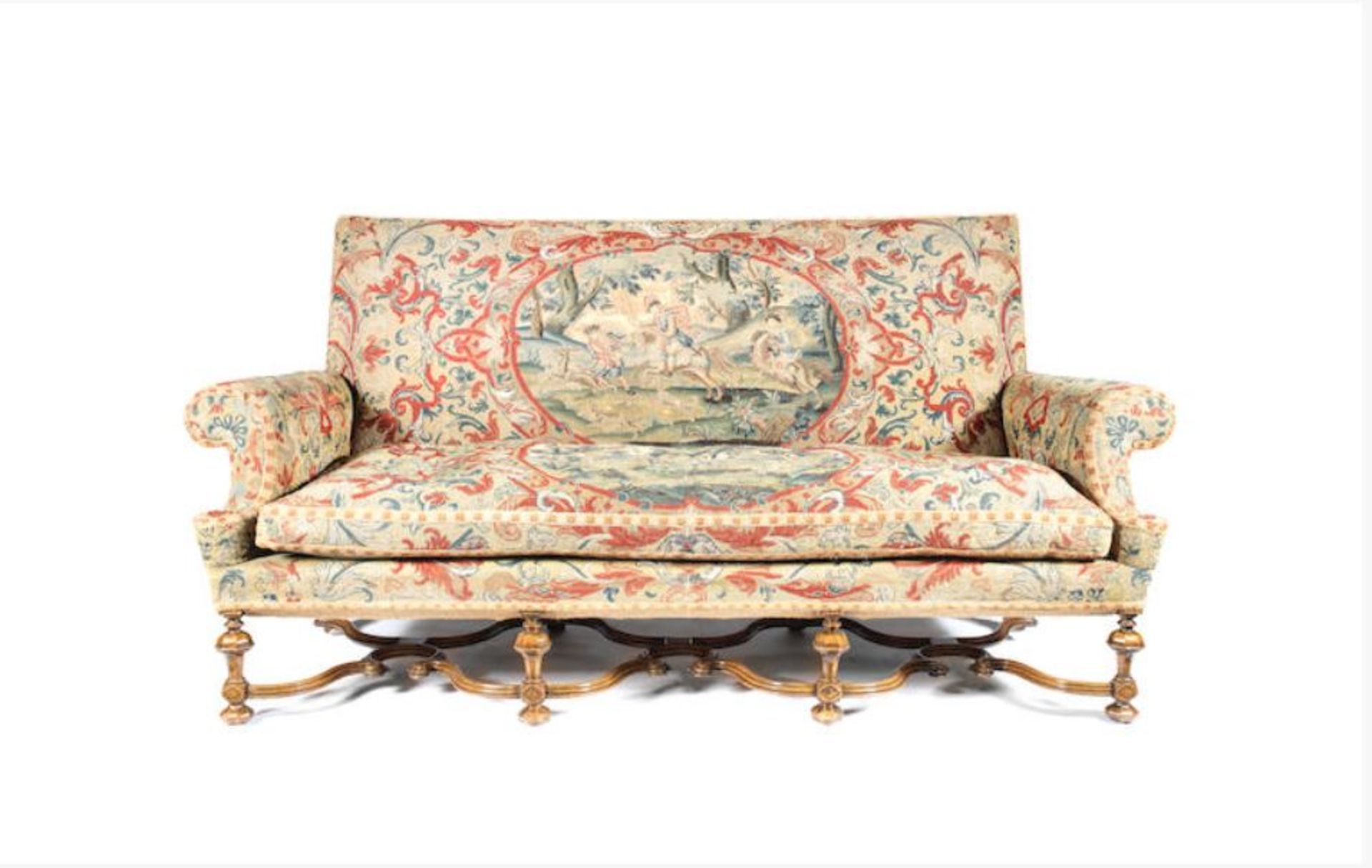 A late Victorian or Edwardian walnut sofa 1900-1910, in the William and Mary style