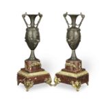 A pair of late 19th century patinated and gilt bronze garniture urns in the Neo-Grec taste