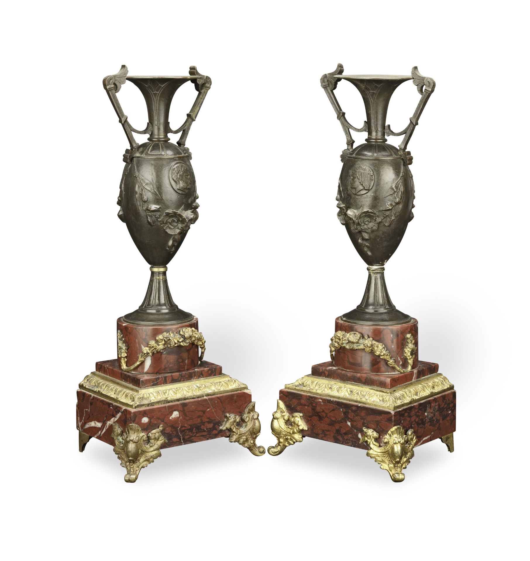 A pair of late 19th century patinated and gilt bronze garniture urns in the Neo-Grec taste