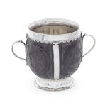 HISTORICALLY IMPORTANT: a 17th century Irish silver mounted twin-handled coconut cup unmarked