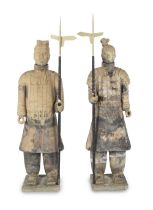 A pair of reproduction fired unglazed clay near life-size models of warriors from the ancient Ch...