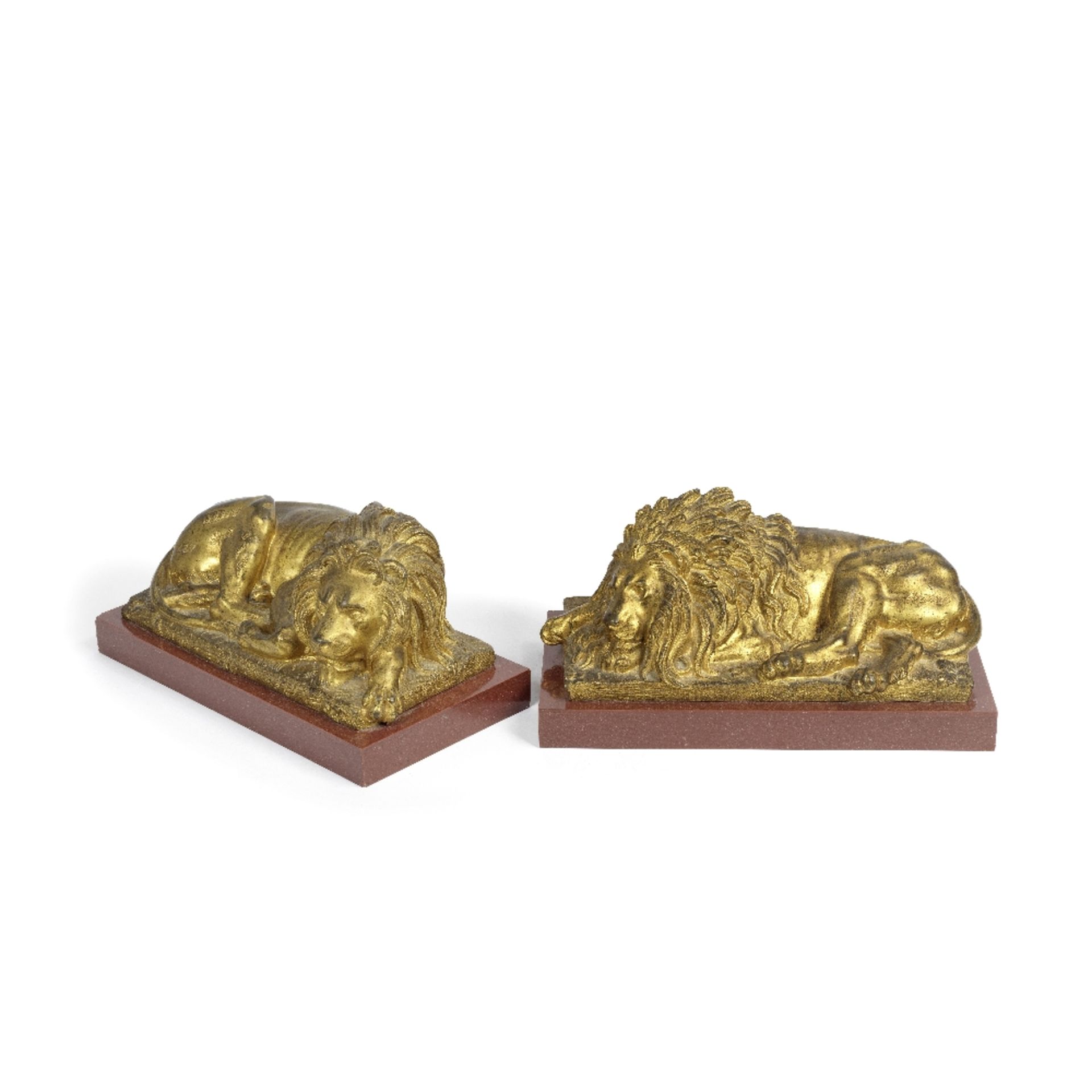 A pair of late 19th century gilt bronze models of sleeping lions after Antonio Canova (Italian, ...