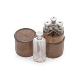 A Victorian leather cased set of four silver and enamel topped glass bottles possibly George Bra...