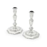 A pair of cast silver candlesticks with London Assay Office cancelled marks for Joseph Walker, D...