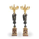 A pair of late 19th century gilt and patinated bronze and rouge marble figural six-light candela...