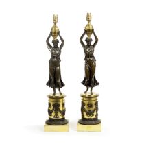 A pair late 19th century patinated and parcel gilt bronze figural candelabra later converted to ...