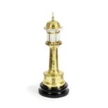 A late 19th century polished brass novelty lighthouse lamp with engraved presentation inscriptio...