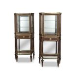 A pair of French late 19th/early 20th century gilt bronze mounted mahogany vitrines in the Louis...
