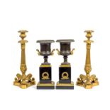 A pair of Charles X gilt bronze candlesticks together with a pair of gilt bronze and patinated g...