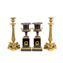 A pair of Charles X gilt bronze candlesticks together with a pair of gilt bronze and patinated g...