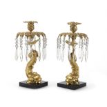 A pair of gilt bronze dolphin form lustre candlesticks (2)