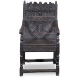 A Charles II or late 17th century carved oak panel back armchair 1670-1690, of North Country origin