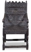 A Charles II or late 17th century carved oak panel back armchair 1670-1690, of North Country origin