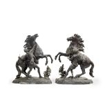 A pair of late 19th/early 20th century French patinated bronze models of the Marley Horses after...