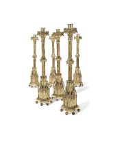 A set of six impressive mid 19th century brass Gothic Revival altar candlesticks in the manner ...