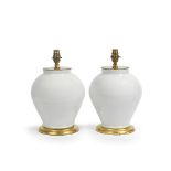A pair of Chinese white glazed porcelain vases, later adapted as lamp bases probably late 19th c...