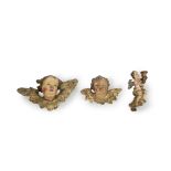A group of three South German or Northern Italian polychrome and giltwood putti carvings probabl...