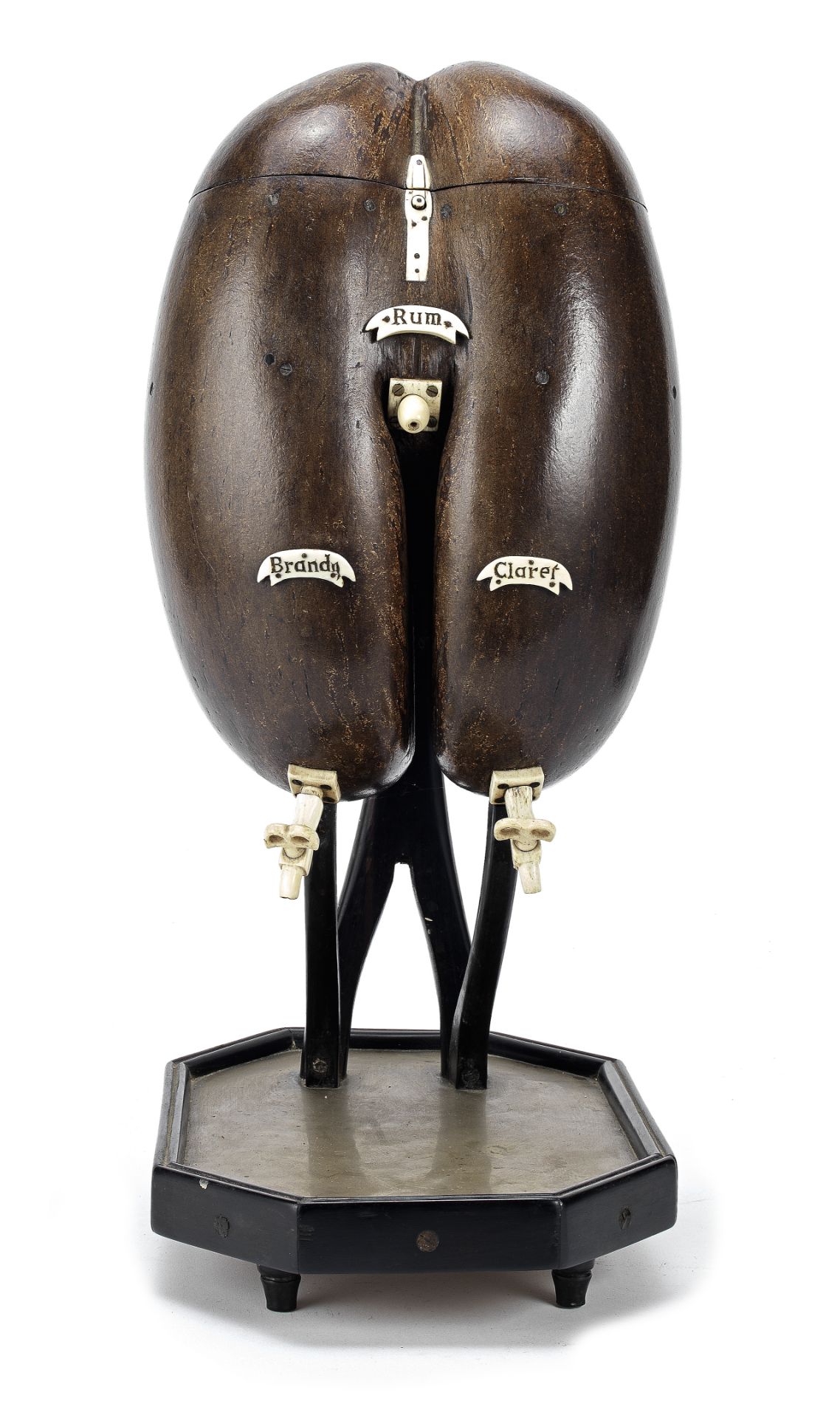 An unusual late 19th/early 20th century bone mounted Coco de Mer liquor or spirit dispenser on s...