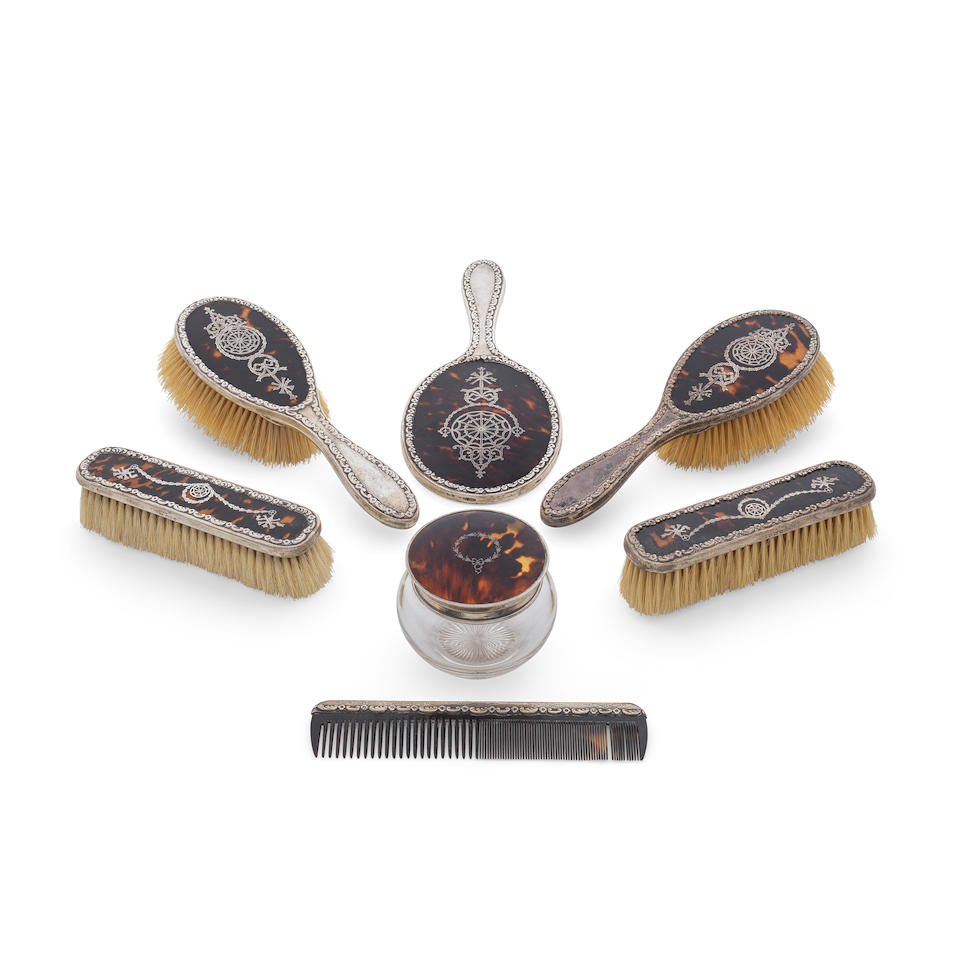 A matched set of seven silver and tortoiseshell dressing table items the majority James Deakin &...