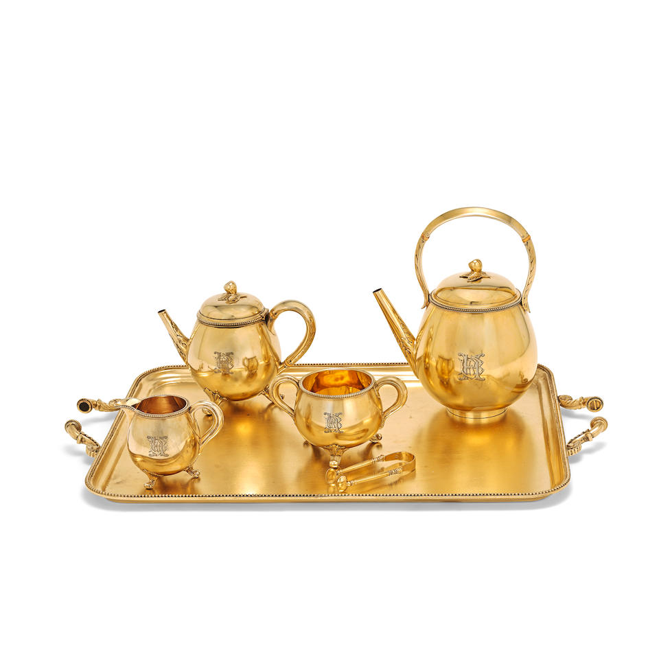 A matched Victorian silver-gilt four-piece tea service together with a matched modern tray Rober...