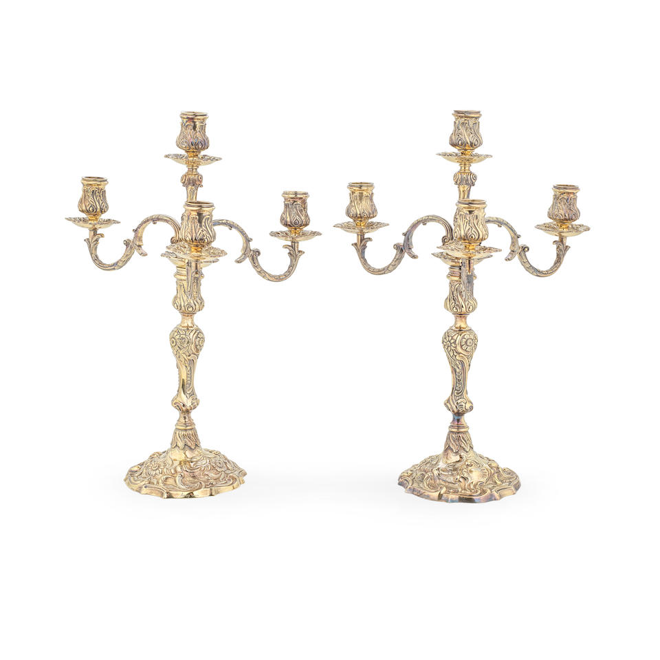 A pair of George II cast silver-gilt candlesticks with Victorian four-light branch sections Joh...