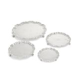 Four silver shaped-circular salvers Fordham & Faulkner, Sheffield 1910; Thomas Bradbury & Sons L...