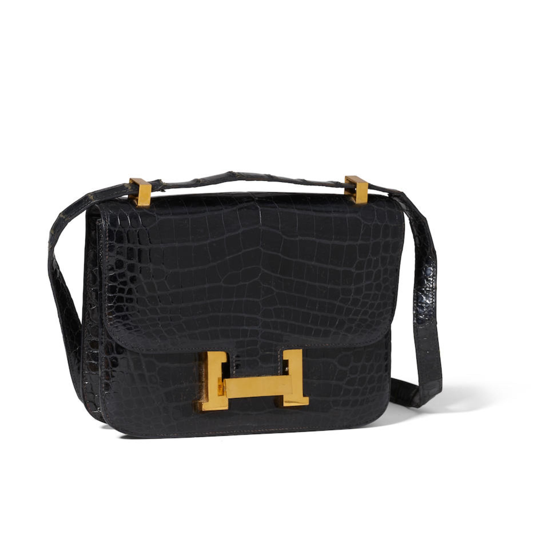 HERMÈS: SHINY POROSUS CROCODILE CONSTANCE 23CM 1972