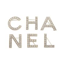Virginie Viard for Chanel: a Set of 'CHANEL' Letter Brooches 2020 (includes box)