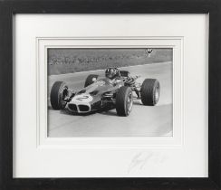 A framed photograph of Graham Hill in the Lotus 59B,