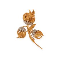 AN 18K BI-COLOR GOLD AND DIAMOND FLORAL BROOCH