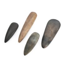 Three New Guinea and one Solomon Islands stone adze blades lg. 7 1/2, 6 3/4, 9 1/2, and 10 1/2 in.