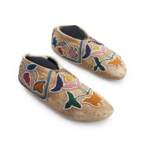 A pair of Prairie beaded hide moccasins lg. 10 1/2 in.