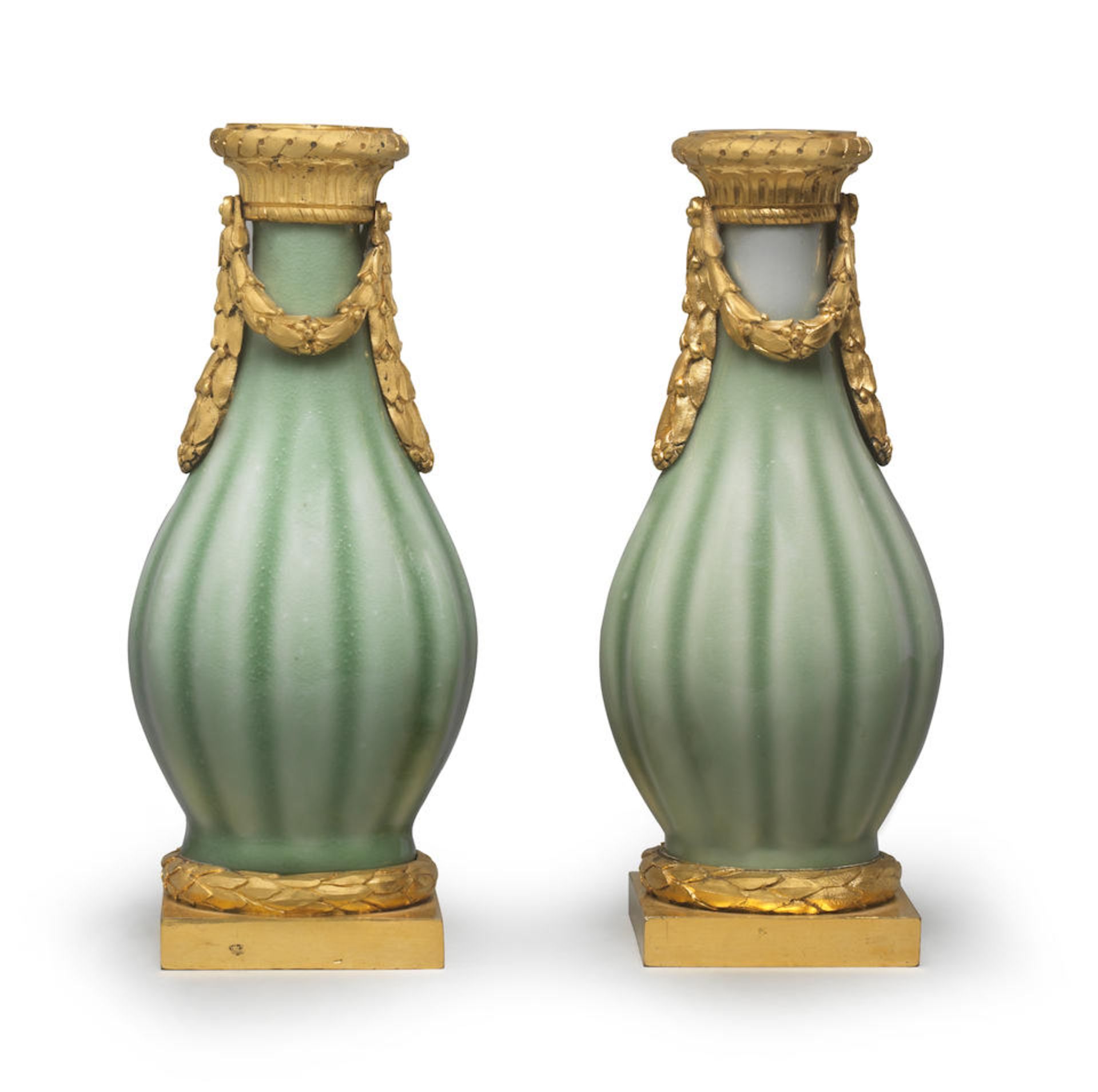 A FINE AND RARE PAIR OF CELADON-GLAZED ORMOLU-MOUNTED VASES The porcelain 18th century, the Fren...