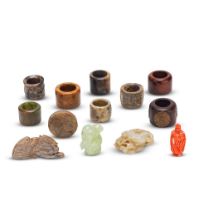 A COLLECTION OF JADE CARVINGS, JADE AND WOOD ARCHERS' RINGS AND A CORAL SNUFF BOTTLE 19th/20th c...