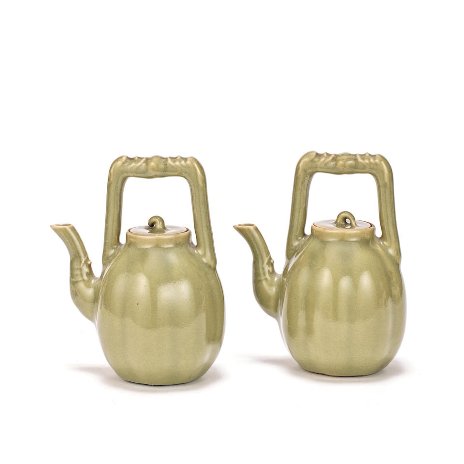 A PAIR OF CELADON-GLAZED TEAPOTS AND COVERS Qianlong seal marks, 19th/early 20th century (4)
