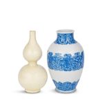 A BLUE AND WHITE ARCHAISTIC VASE AND A CARVED SOFT PASTE DOUBLE GOURD VASE 18th century (2)