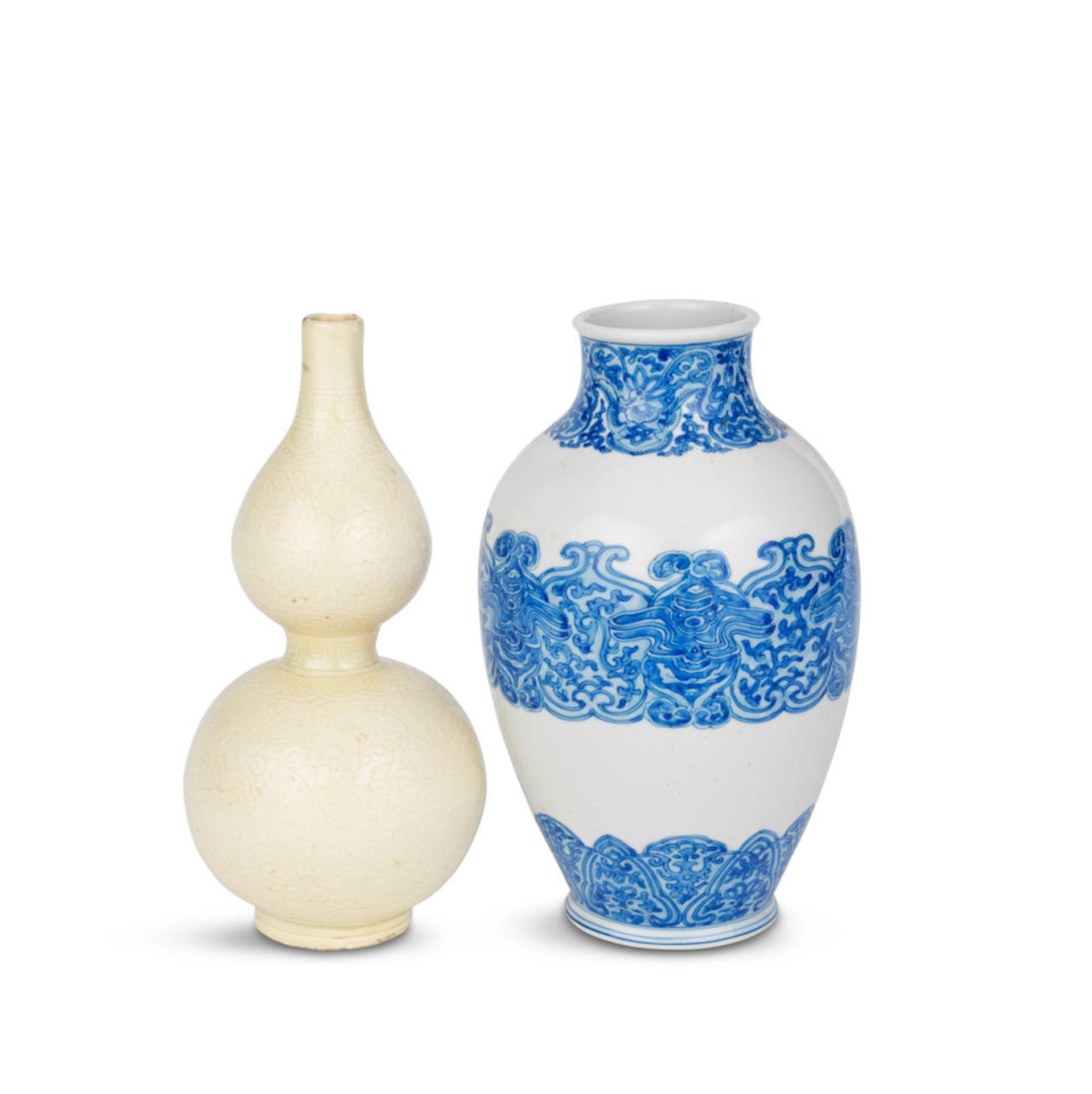 A BLUE AND WHITE ARCHAISTIC VASE AND A CARVED SOFT PASTE DOUBLE GOURD VASE 18th century (2)