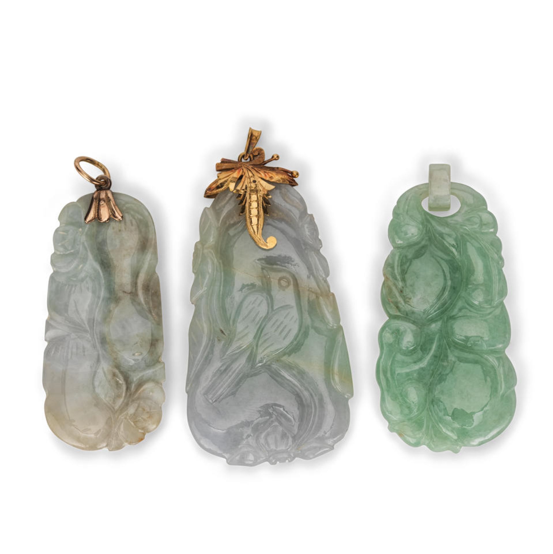 A GROUP OF THREE CARVED JADEITE PENDANTS 20th century (3)