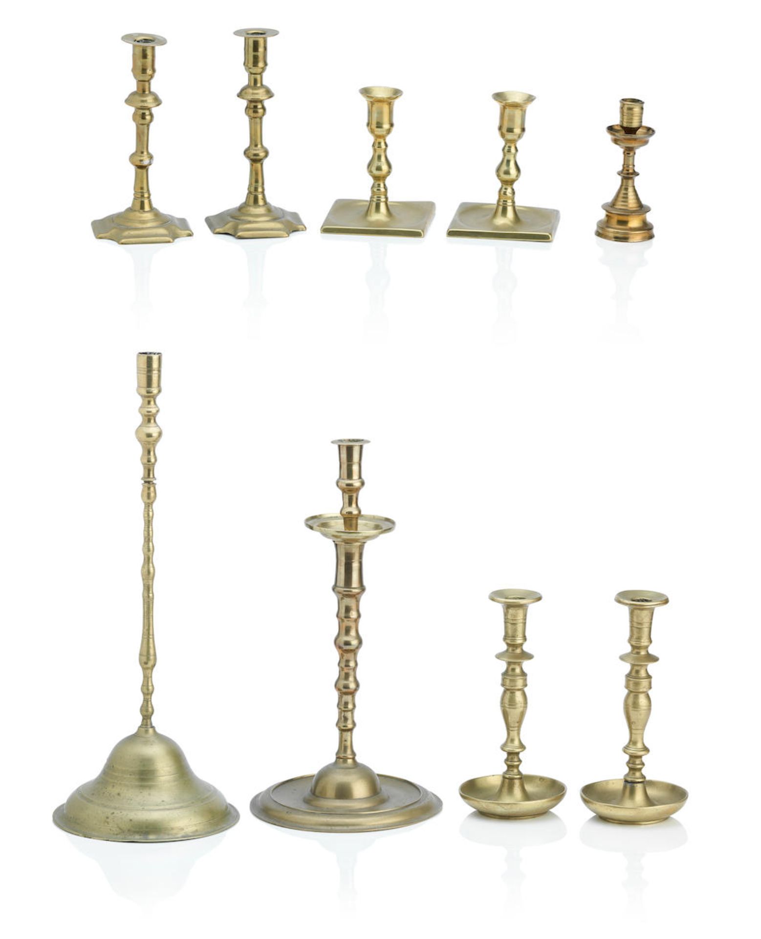 A pair of English seamed brass candlesticks Mid 18th Century (9)