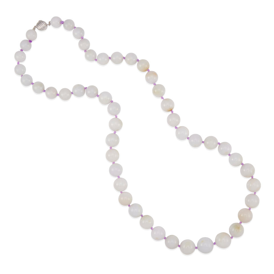 A STRAND OF LAVENDER JADE BEADS